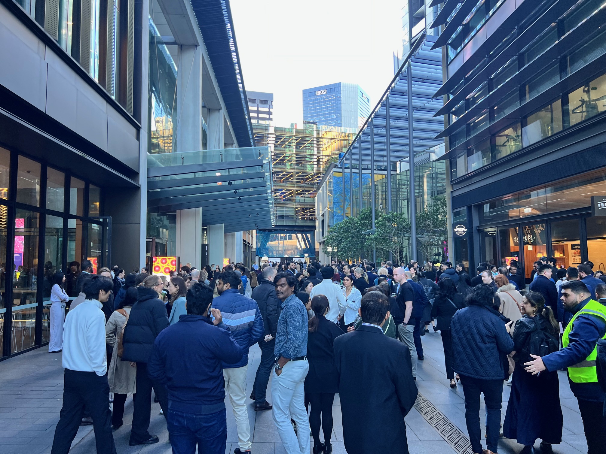 Office workers gathered at an assembly area outside a building