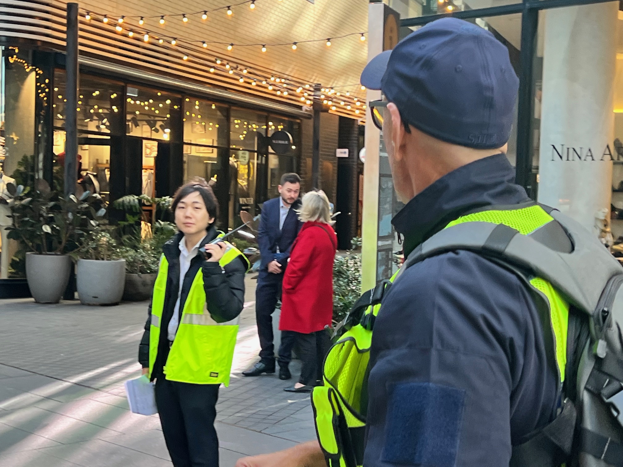 Wardens in hi-vis vests coordinating at a building entrance during an exercise